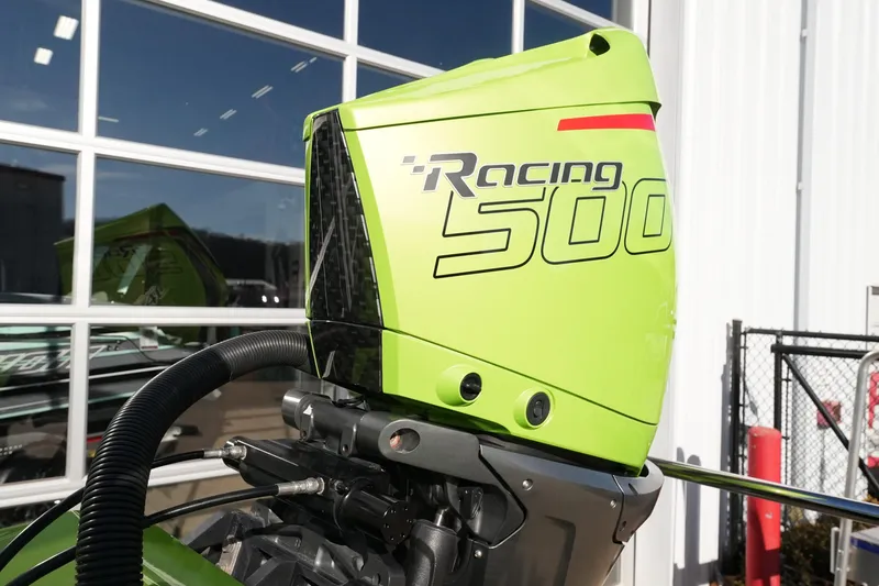 Slide: The Image of Bright green MTI 440X Racing 500 outboard motor, 2025 model, against a garage backdrop. - 18