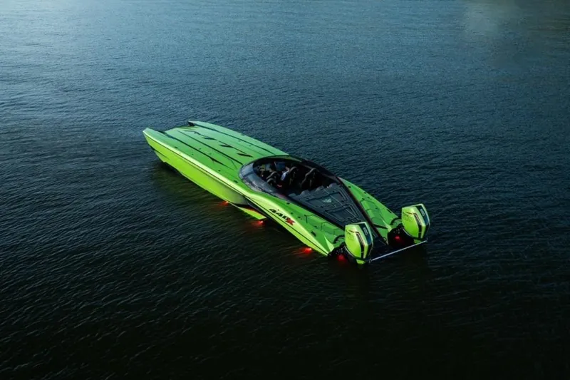 Slide: The Image of Bright green MTI 440X powerboat, 2025 model, on a trailer outside a garage. - 2