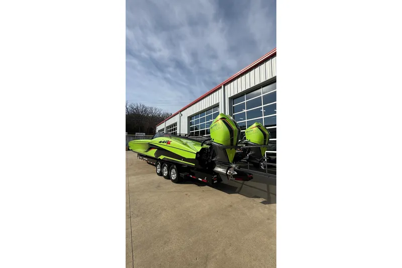 Slide: The Image of Bright green 2025 MTI 440X powerboat with dual engines on a trailer. - 21