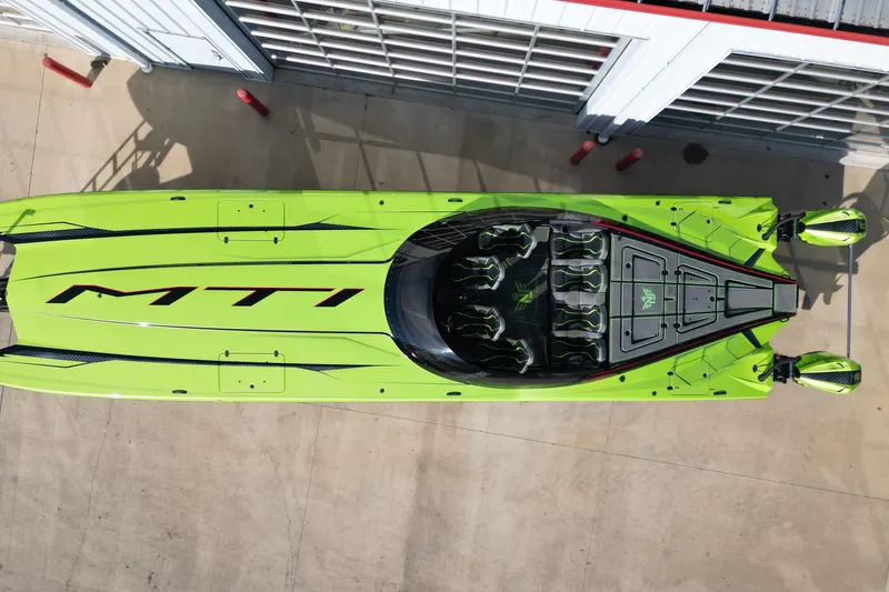 Slide: The Image of Aerial view of a vibrant green 2025 MTI 440X speedboat docked. - 25