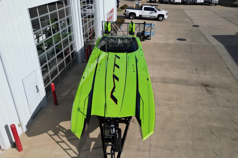 Slide: The Image of Bright green MTI 440X speedboat, 2025 model, parked outside a garage. - 27