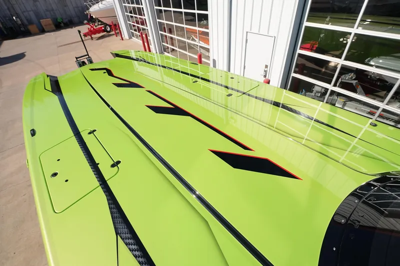 Slide: The Image of Bright green MTI 440X boat, 2025 model, with sleek black and red accents. - 34