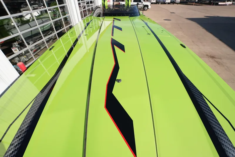 Slide: The Image of Bright green MTI 440X boat with sleek black and red accents, 2025 model. - 36