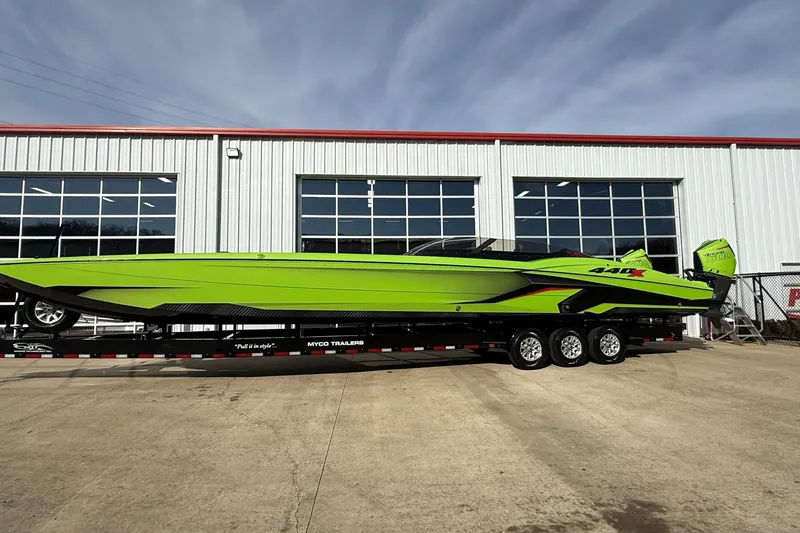 Slide: The Image of Bright green 2025 MTI 440X powerboat on trailer, parked outside industrial building. - 37