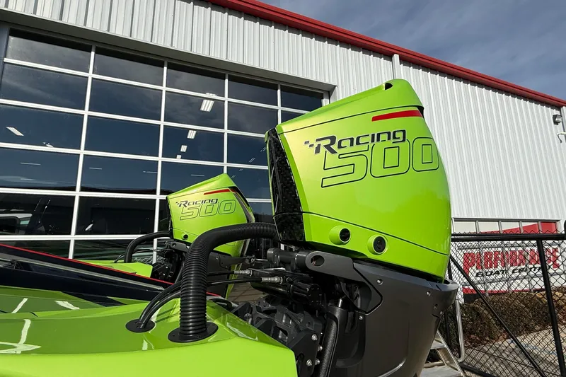 Slide: The Image of Bright green MTI 440X Racing 500 outboard motors, 2025 model, against industrial building backdrop. - 38