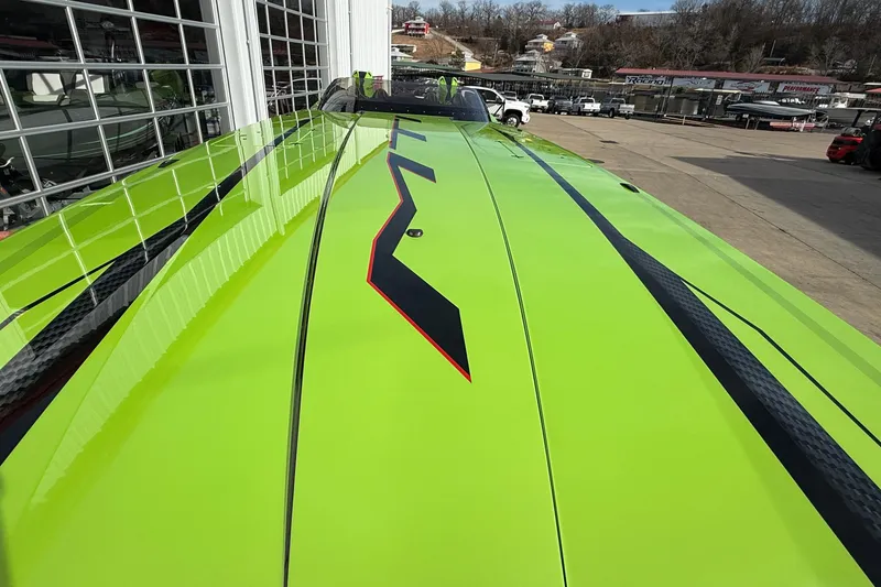 Slide: The Image of Bright green MTI 440X boat with sleek black and red accents, 2025 model. - 40