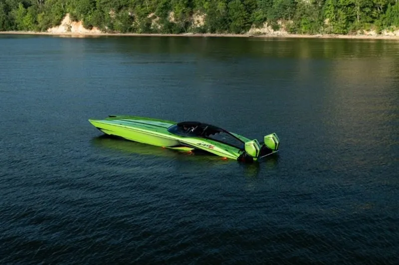 Slide: The Image of Aerial view of a vibrant green 2025 MTI 440X powerboat docked on concrete. - 5