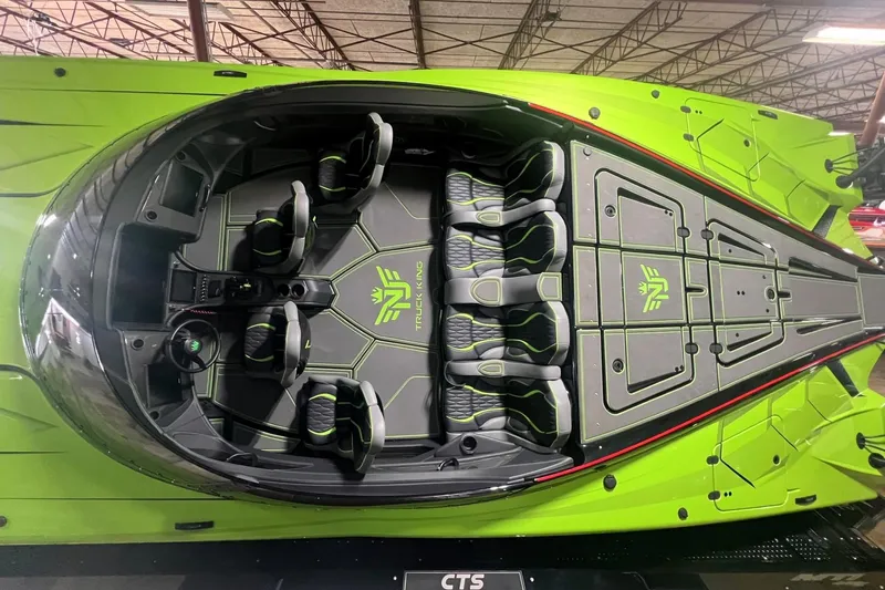 Slide: The Image of Green MTI 440X boat with Racing 300 engine, 2025 model, outside a glass-paneled building. - 8