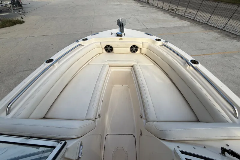 Slide: The Image of 2019 Grady-White Freedom 235 boat interior with white cushioned seating and stainless steel railings. - 10