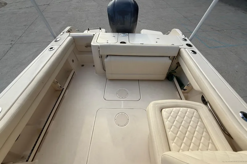 Slide: The Image of 2019 Grady-White Freedom 235 boat interior with cushioned seating and spacious deck. - 12