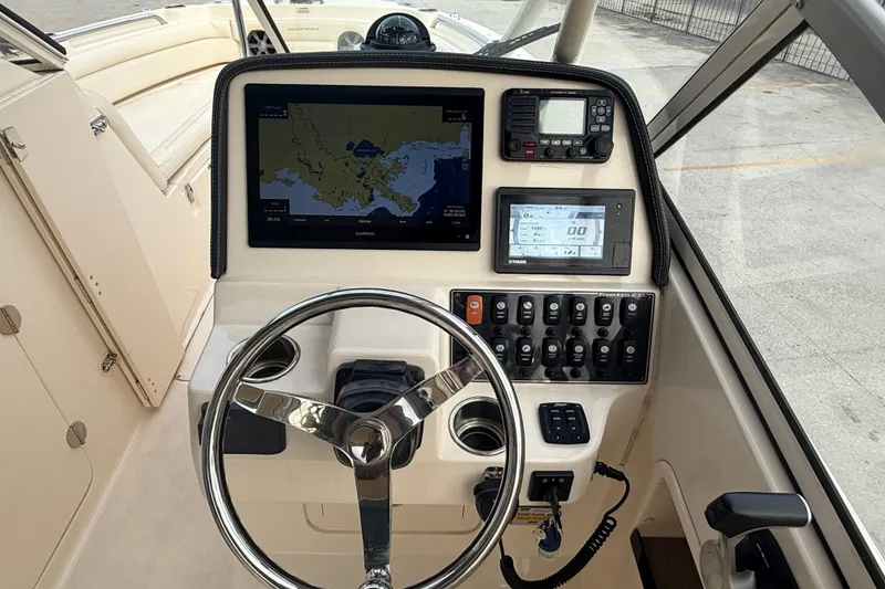 Slide: The Image of 2019 Grady-White Freedom 235 boat dashboard with navigation and control systems. - 15