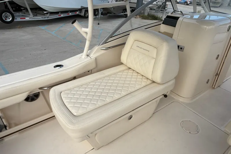 Slide: The Image of 2019 Grady-White Freedom 235 boat interior with luxurious white seating. - 19