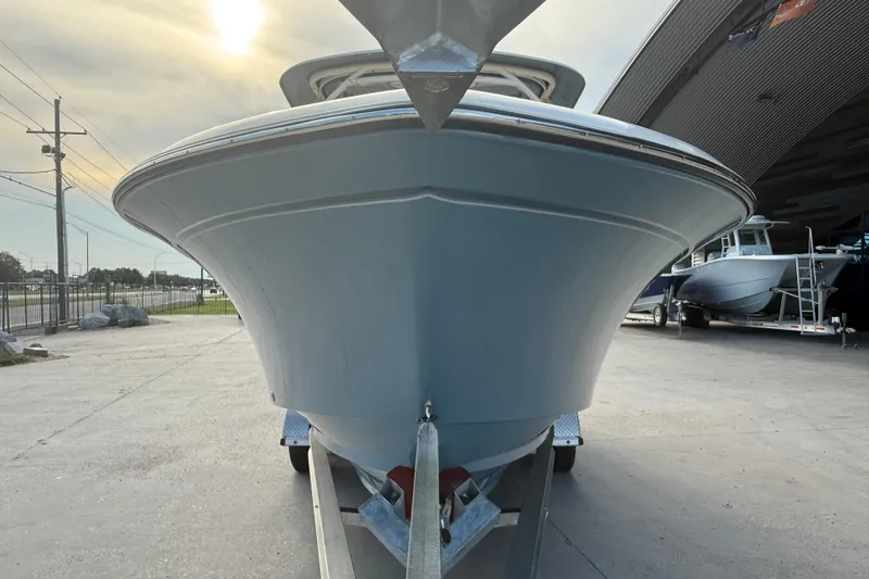 Slide: The Image of 2019 Grady-White Freedom 235 boat on trailer, viewed from the front. - 2