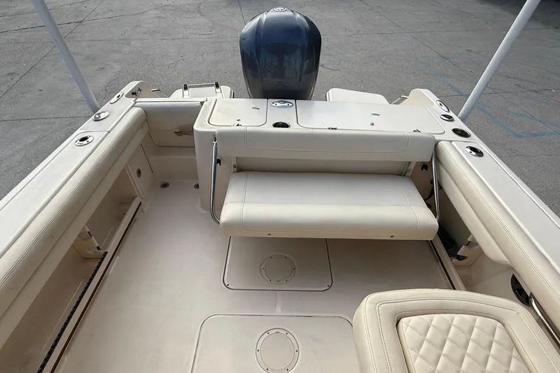 Slide: The Image of 2019 Grady-White Freedom 235 boat interior with seating and engine view. - 21