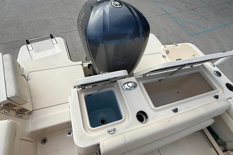 Slide: The Image of 2019 Grady-White Freedom 235 boat with open storage compartments and engine view. - 22