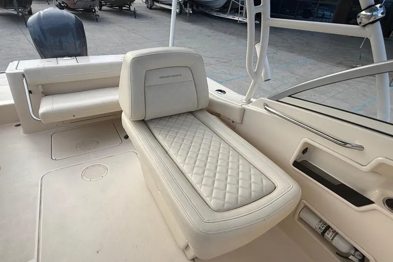 Slide: The Image of 2019 Grady-White Freedom 235 boat interior with cushioned seating and storage. - 23