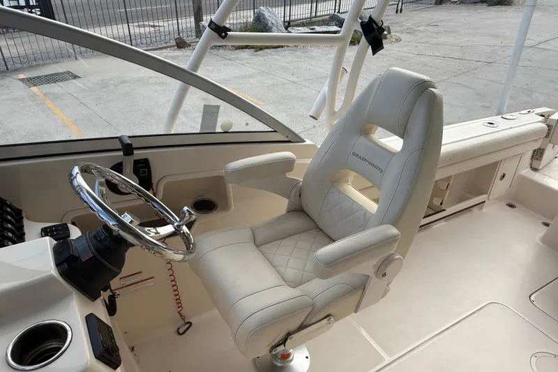 Slide: The Image of 2019 Grady-White Freedom 235 boat interior with captain's chair and steering wheel. - 25