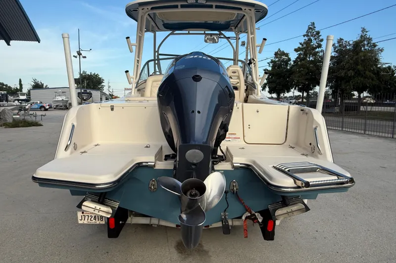 Slide: The Image of 2019 Grady-White Freedom 235 boat with outboard motor, docked on concrete surface. - 5