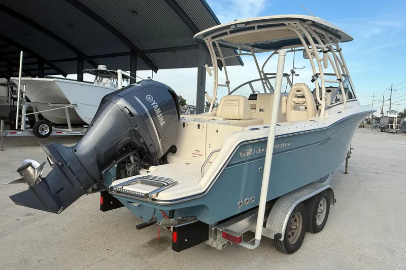 Slide: The Image of 2019 Grady-White Freedom 235 boat with Yamaha engine on trailer, parked outdoors. - 6