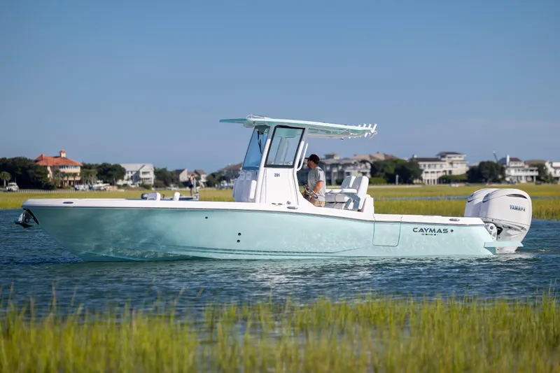 The Image of 2026 Caymas 291 HB boat cruising on a serene waterway with coastal homes in the background. - 0