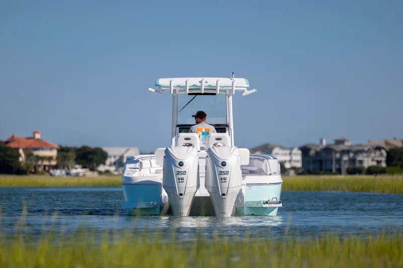Slide: The Image of 2026 Caymas 291 HB boat cruising on calm water with scenic background. - 1