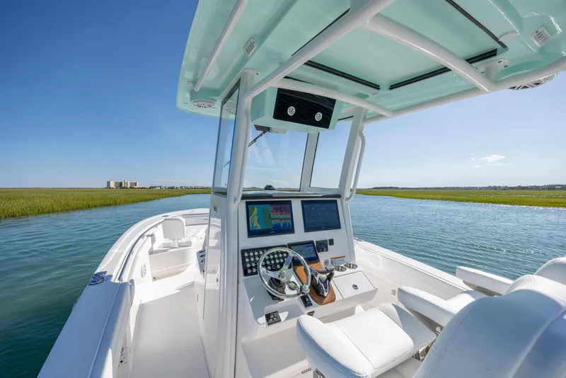 Slide: The Image of 2026 Caymas 291 HB boat interior with modern dashboard on a serene waterway. - 15