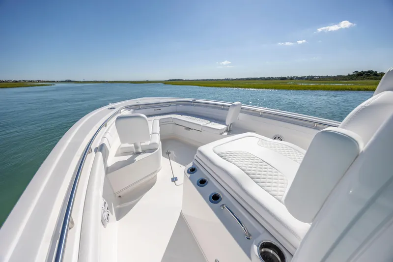 Slide: The Image of 2026 Caymas 291 HB boat on serene water, featuring luxurious white seating and sleek design. - 18