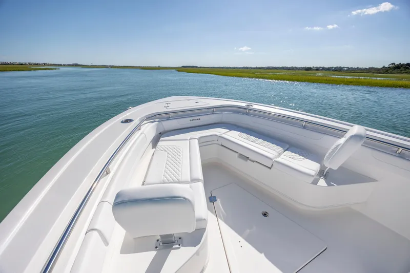 Slide: The Image of 2026 Caymas 291 HB boat interior with white seating on calm water. - 19