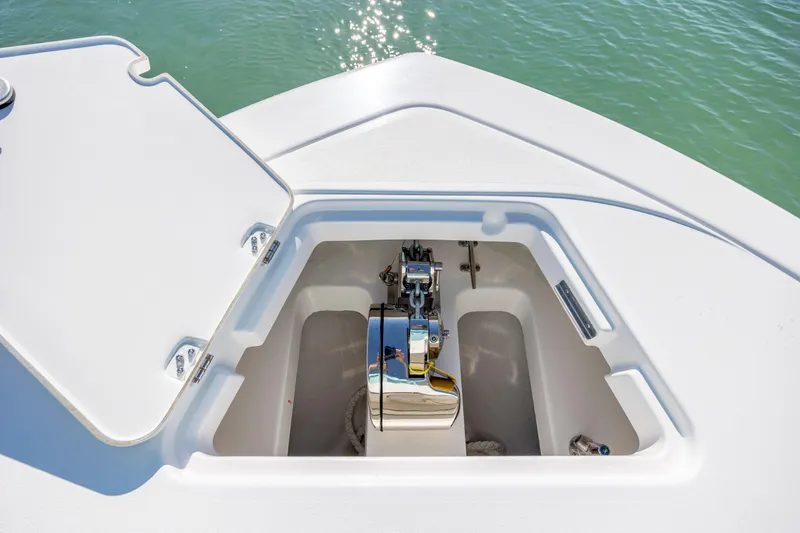 Slide: The Image of Open hatch on 2026 Caymas 291 HB boat, revealing storage compartment and equipment. - 23