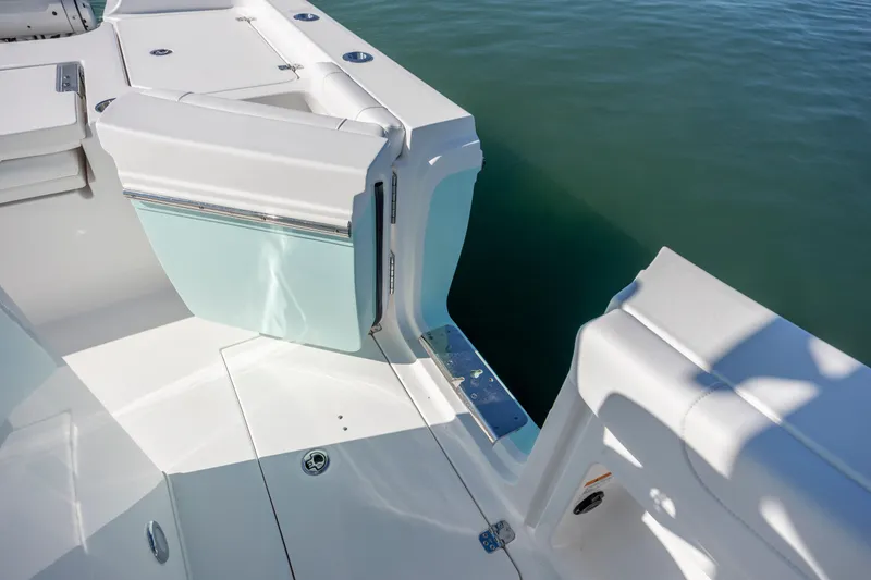 Slide: The Image of 2026 Caymas 291 HB boat with open side door, white interior, and calm water view. - 24