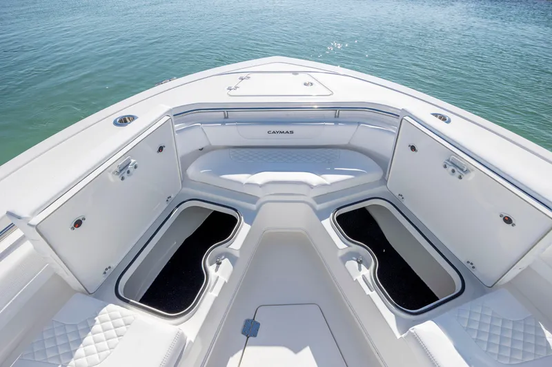 Slide: The Image of 2026 Caymas 291 HB boat interior with open storage compartments on calm water. - 29