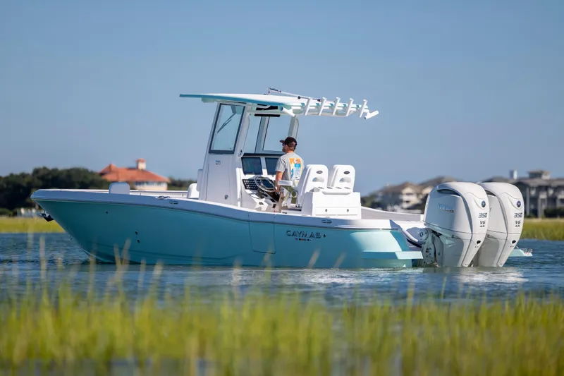 Slide: The Image of 2026 Caymas 291 HB boat cruising on calm water with dual Yamaha engines. - 3