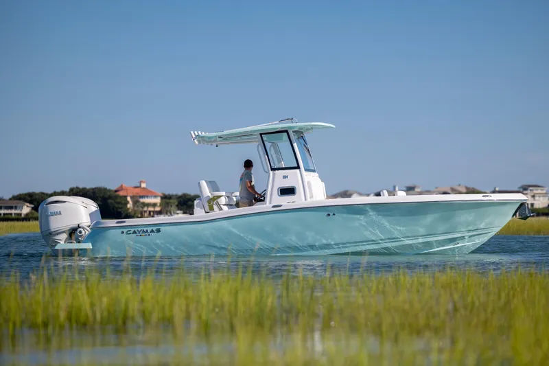 Slide: The Image of 2026 Caymas 291 HB boat cruising on calm water, with scenic background. - 4