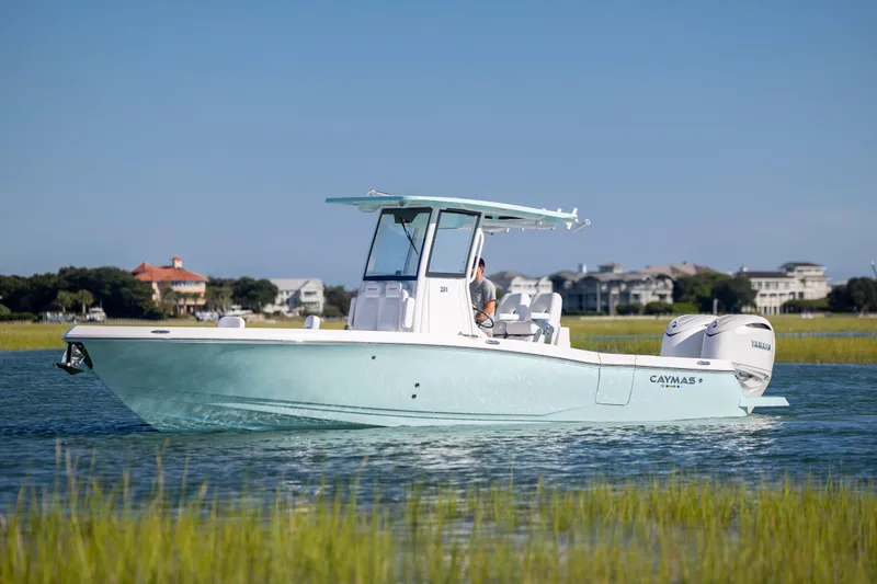 Slide: The Image of 2026 Caymas 291 HB boat cruising on a calm waterway with scenic background. - 5