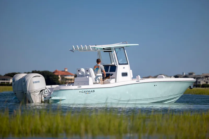 Slide: The Image of 2026 Caymas 291 HB boat with dual Yamaha engines on calm water. - 6