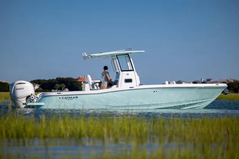 Slide: The Image of 2026 Caymas 291 HB boat cruising on calm water with Yamaha engine. - 7