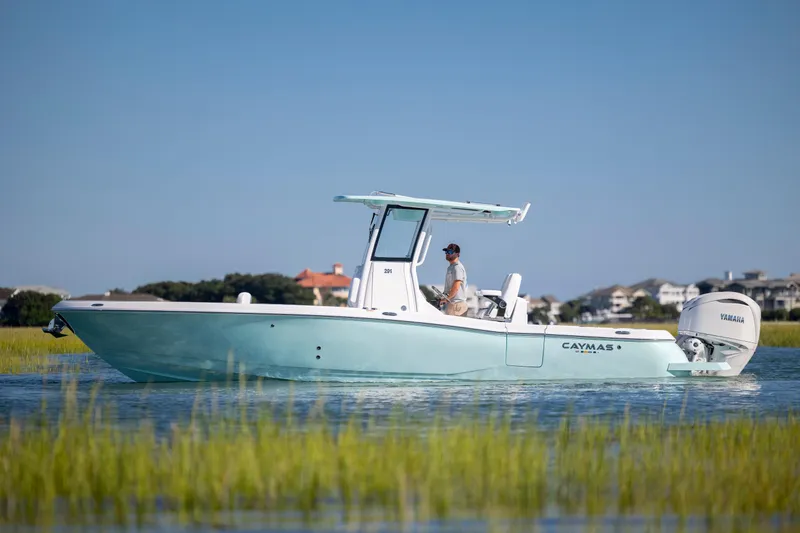 Slide: The Image of 2026 Caymas 291 HB boat cruising on calm water with scenic background. - 8