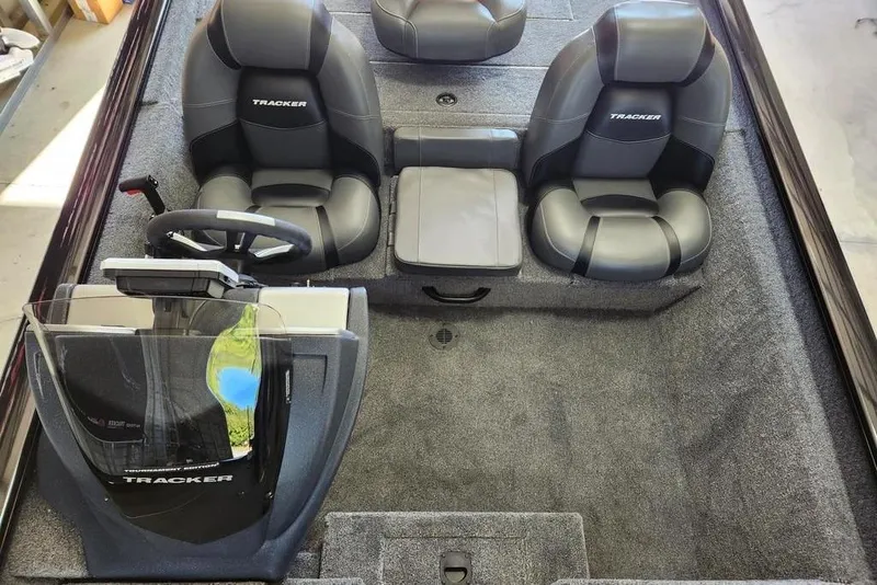 Slide: The Image of 2026 Tracker Pro Team 175 boat interior with dual seats and steering console. - 11