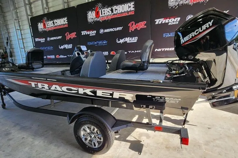 Slide: The Image of 2026 Tracker Pro Team 175 boat with Mercury engine on display indoors. - 3