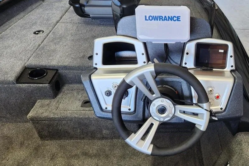 Slide: The Image of 2026 Tracker Pro Team 175 boat dashboard with steering wheel and Lowrance display. - 6