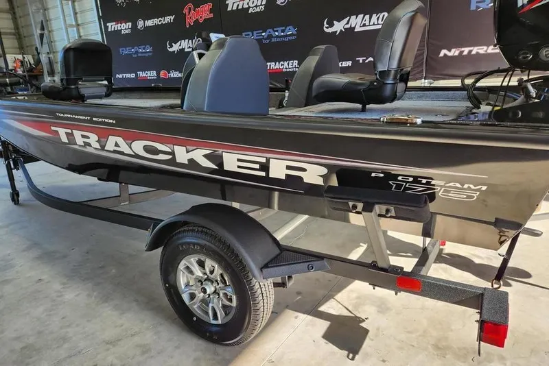 Slide: The Image of 2026 Tracker Pro Team 175 boat on trailer in showroom setting. - 7