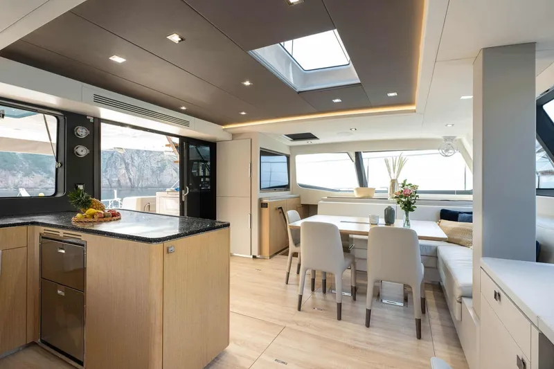 Slide: The Image of Luxurious interior of 2025 Privilege Signature 580 yacht with modern dining area and kitchen. - 31