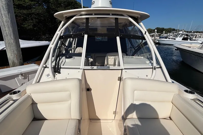 Slide: The Image of 2020 Grady-White Freedom 275 boat interior with seating, docked at marina. - 11