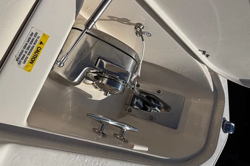 Slide: The Image of Anchor compartment of 2020 Grady-White Freedom 275 boat, featuring stainless steel hardware. - 13