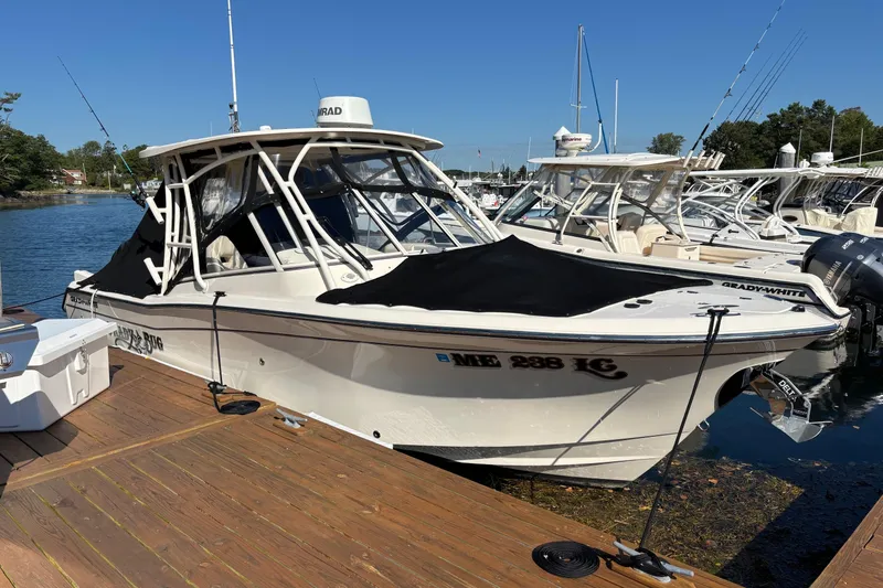 Slide: The Image of 2020 Grady-White Freedom 275 boat docked at marina, covered and ready for adventure. - 2