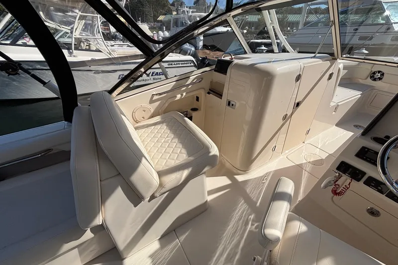 Slide: The Image of 2020 Grady-White Freedom 275 boat interior with white seating and control panel. - 21