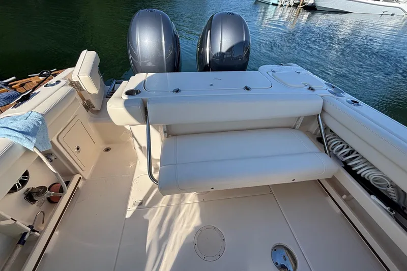 Slide: The Image of 2020 Grady-White Freedom 275 boat interior with dual engines and seating. - 24