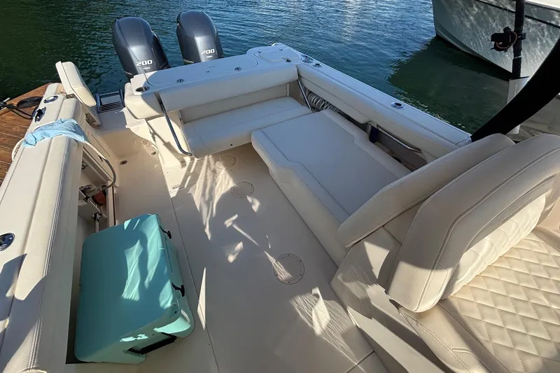 Slide: The Image of 2020 Grady-White Freedom 275 boat interior with seating and twin engines. - 26