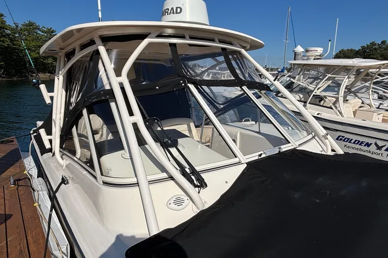 Slide: The Image of 2020 Grady-White Freedom 275 boat docked, featuring a sleek design and enclosed cockpit. - 4