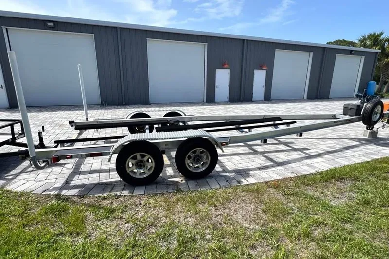 Slide: The Image of 2017 Yellowfin 24 Bay CE boat trailer parked on paved driveway. - 18